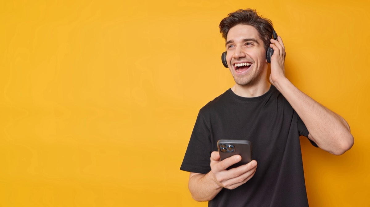 Hands holding a smartphone with a digital music library
