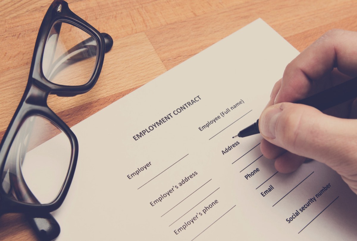 An employee reviewing an employment contract at a desk in a California office