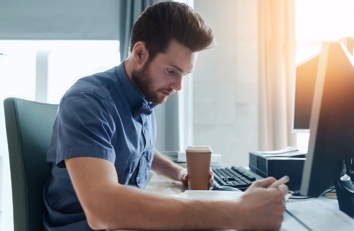 Founder registering a brand name and domain on a laptop