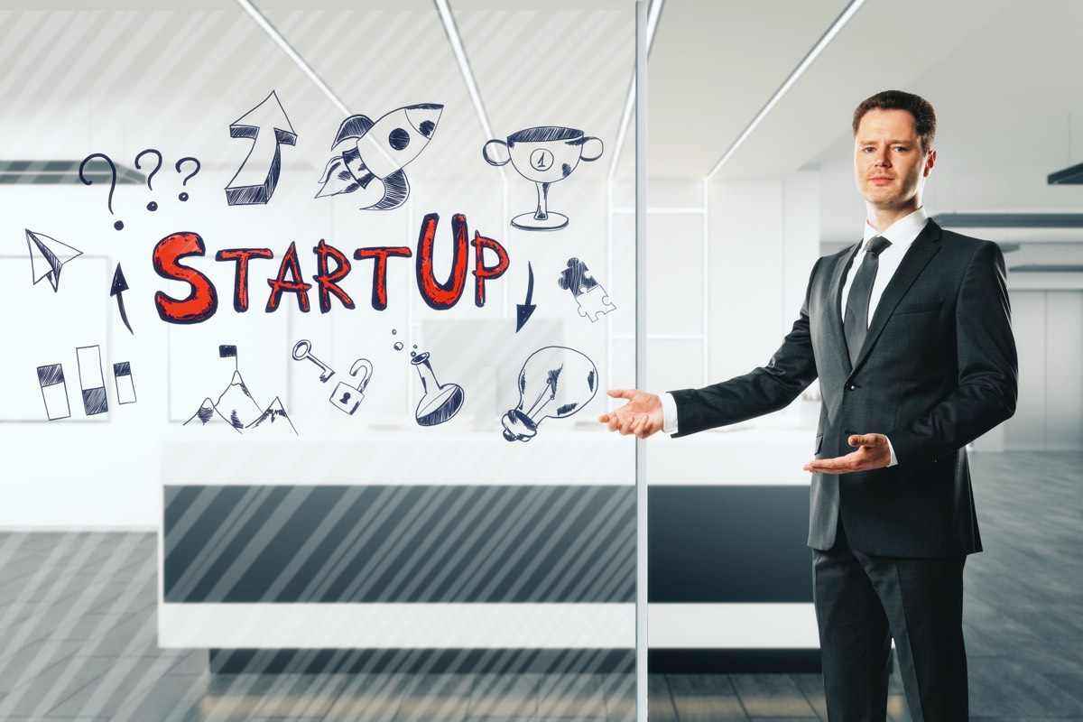Inventor presenting a product prototype to a group of investors in a meeting