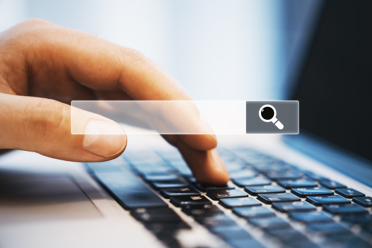 Person searching a patent database on a laptop