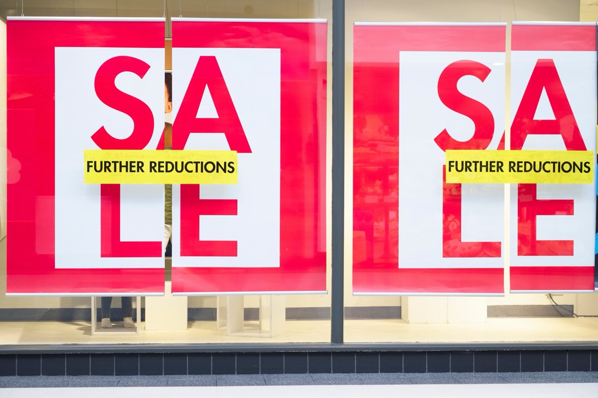 Two similar storefront signs side by side suggesting brand confusion