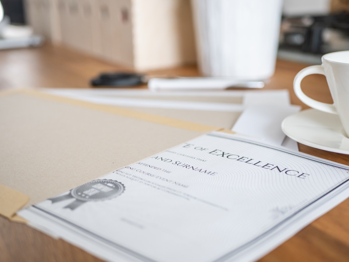Trademark registration certificate and filing documents on an office desk
