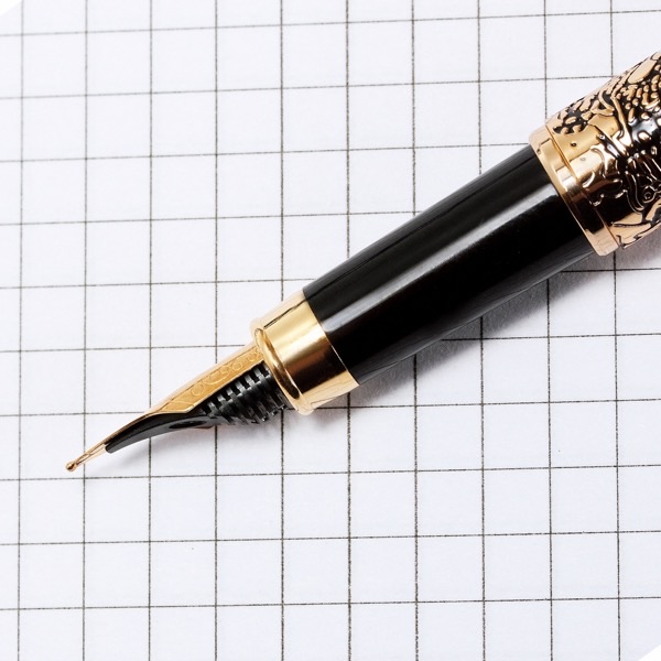 Gold fountain-pen nib resting on paper