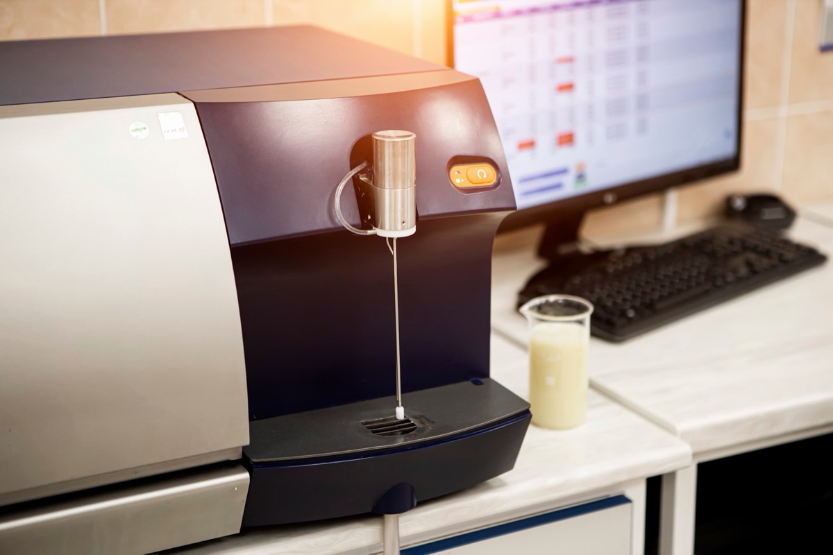 Laboratory chromatography equipment with a scientist reviewing a printed graph