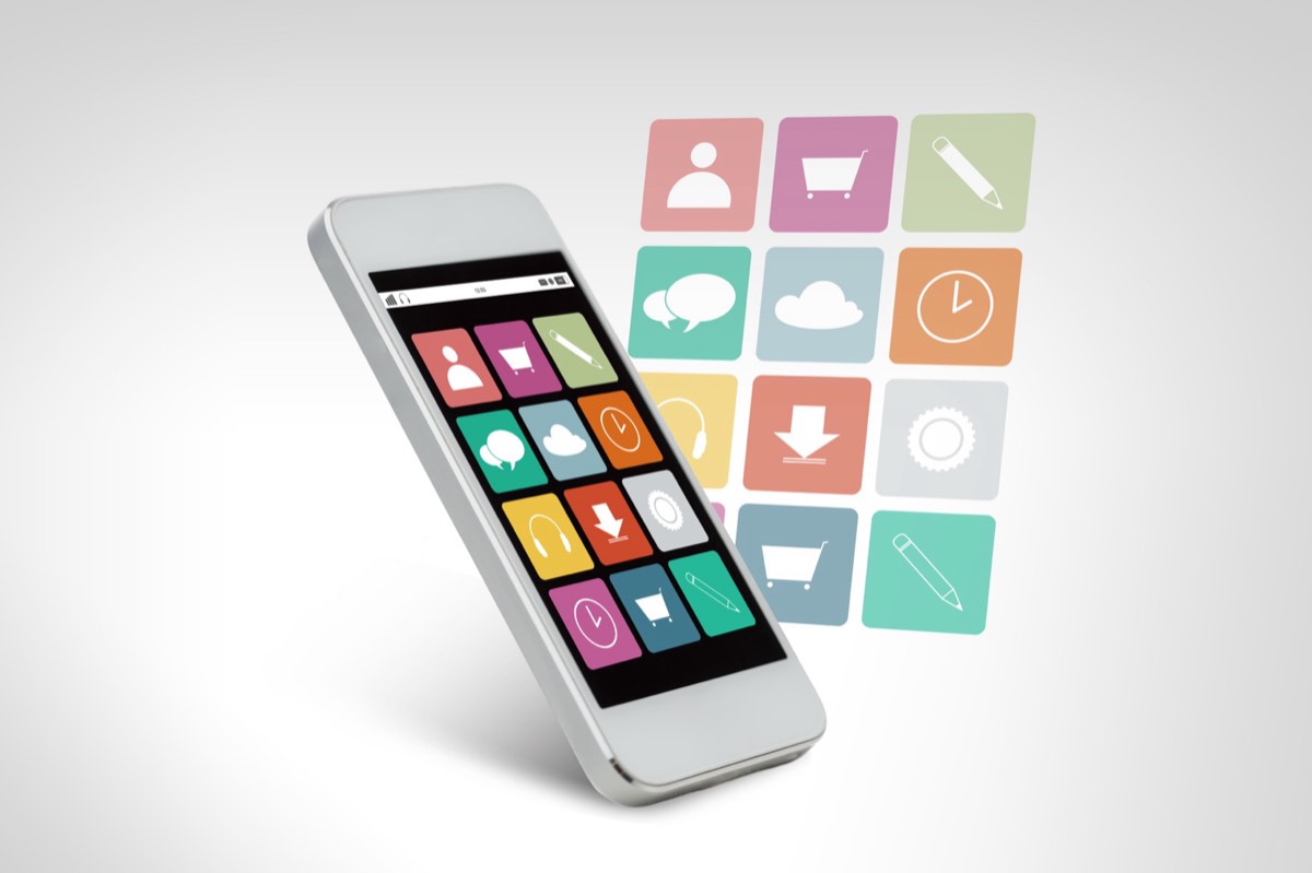 A modern smartphone with a grid of app icons on a black screen