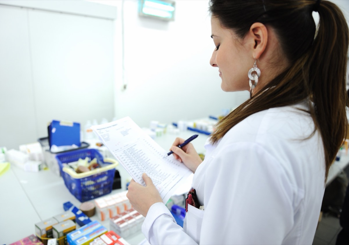 A pharmacist reviewing prescription drug records