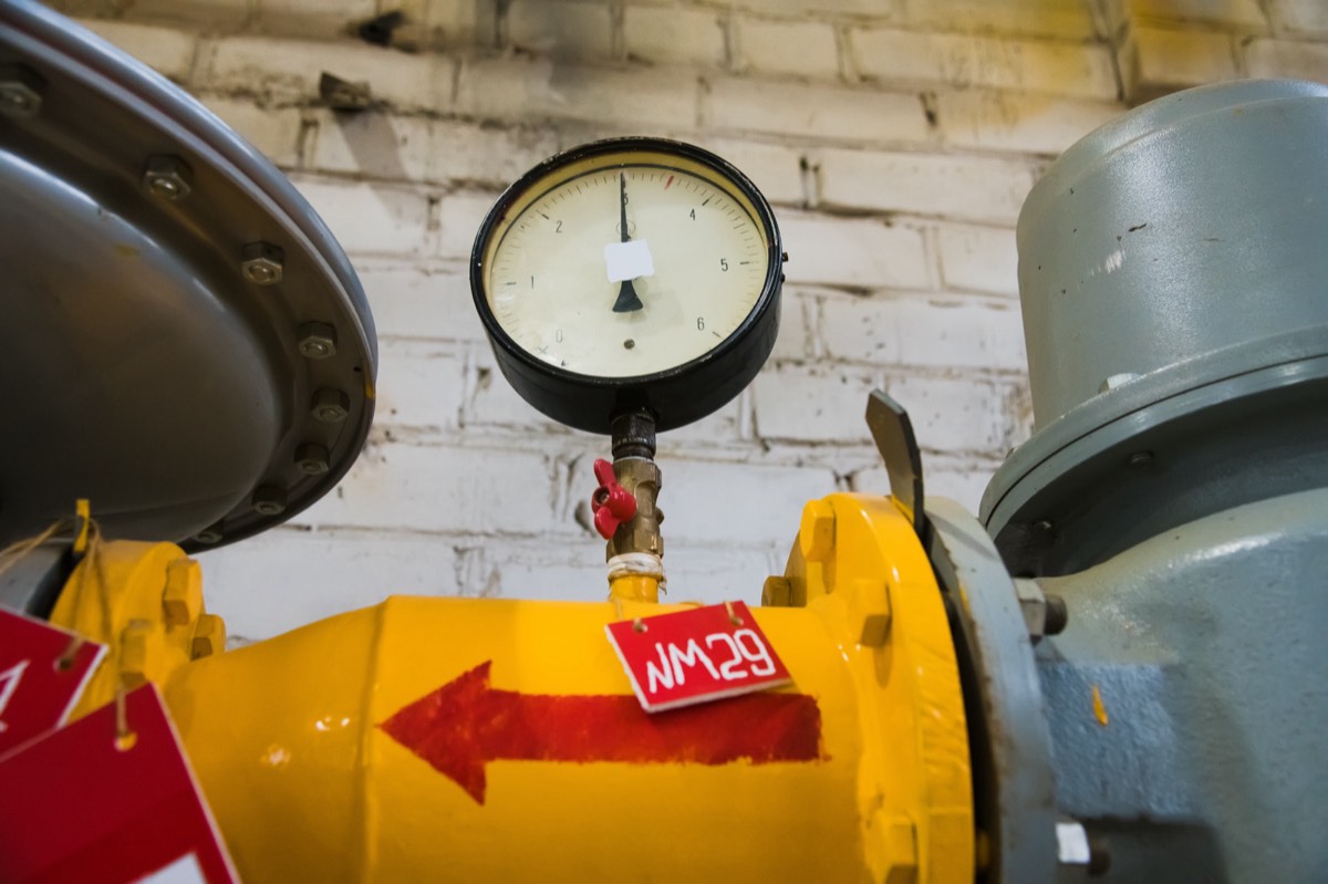 An industrial chemical reactor vessel with temperature and pressure gauges