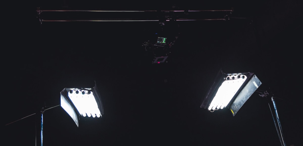 A film set with studio lighting and a camera rig on a soundstage