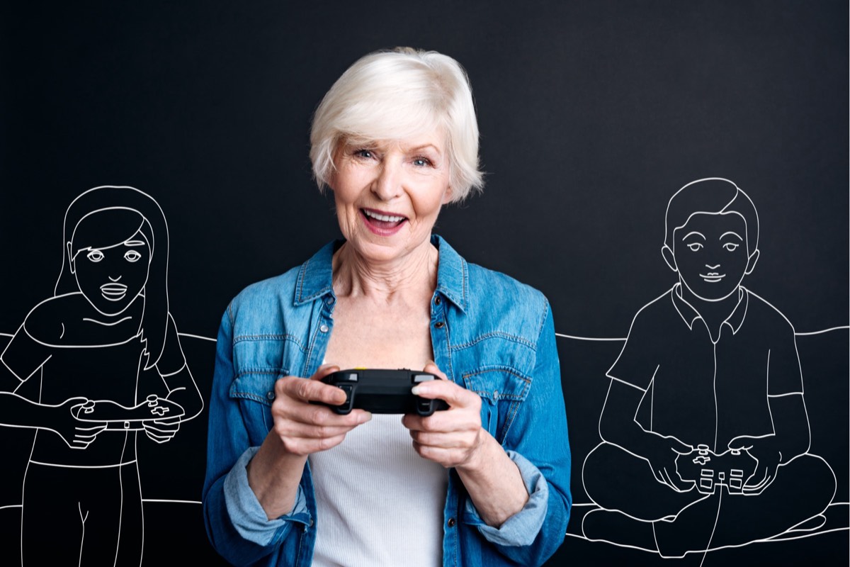 A person playing an open-world video game on a large screen with a character on a city street