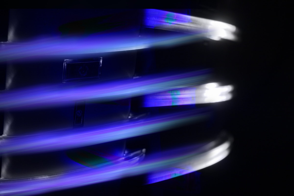 Rows of modular data center server racks under blue lighting