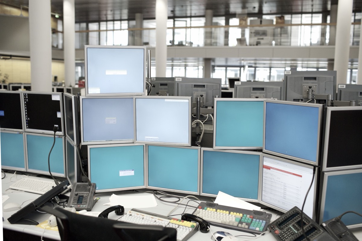 A financial trader studying multiple market data screens