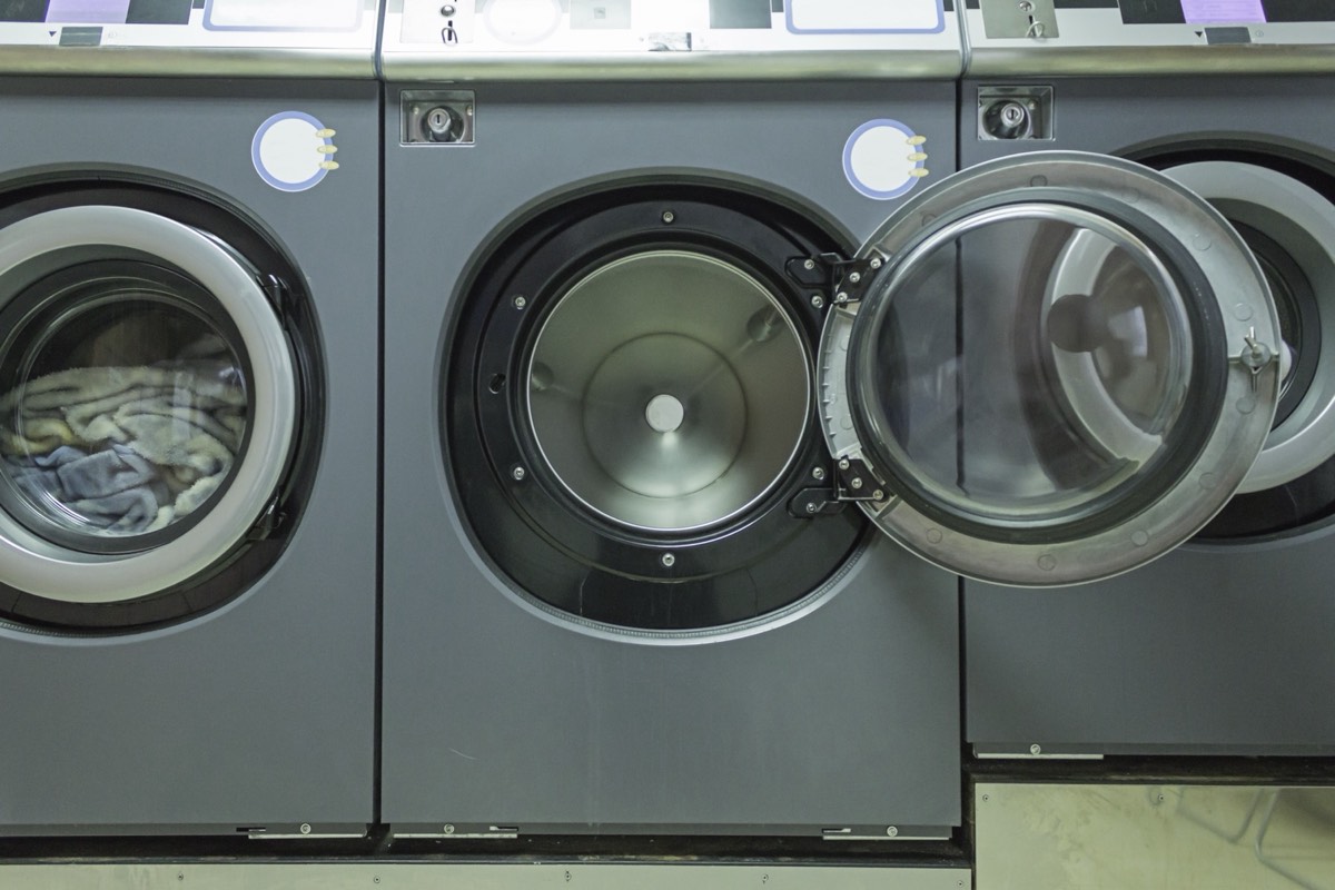 Interior of an industrial commercial laundry with rows of washing machines