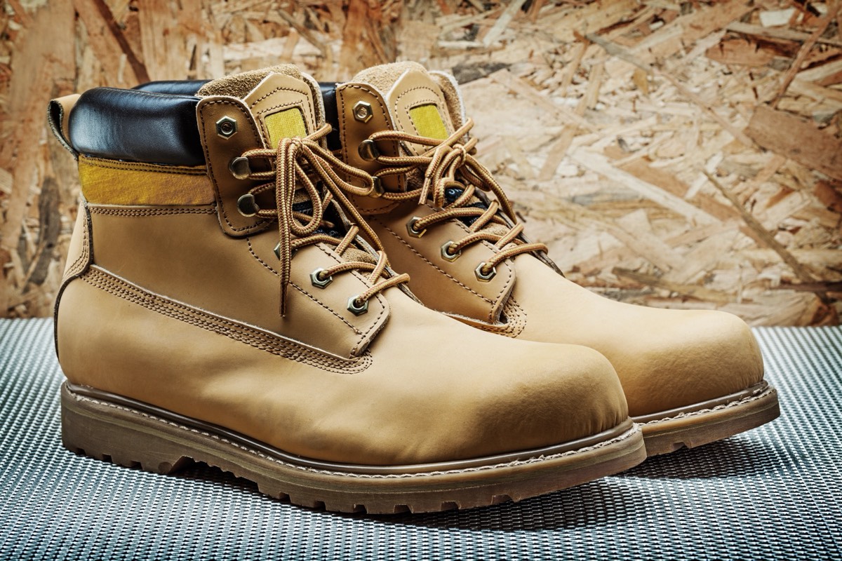 A tan lace-up leather work boot photographed against a neutral background