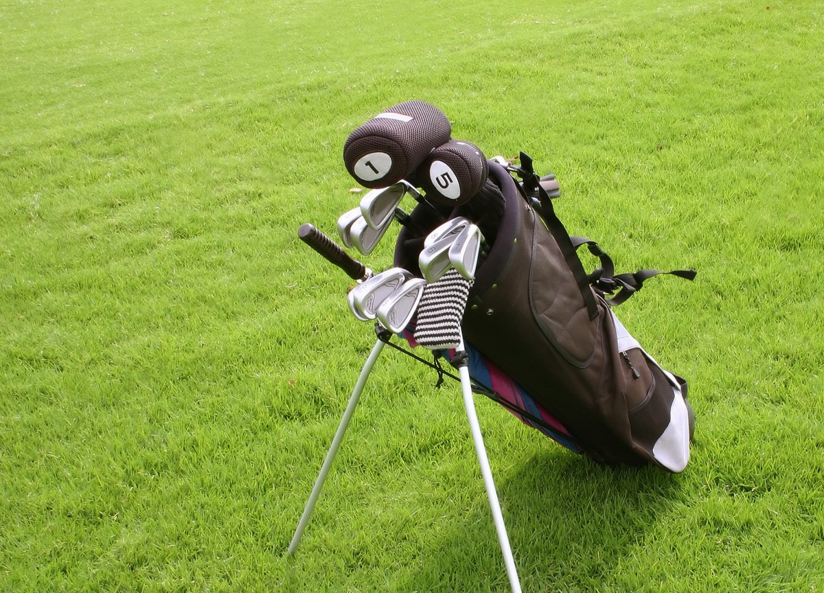 Golf clubs in a bag on a fairway